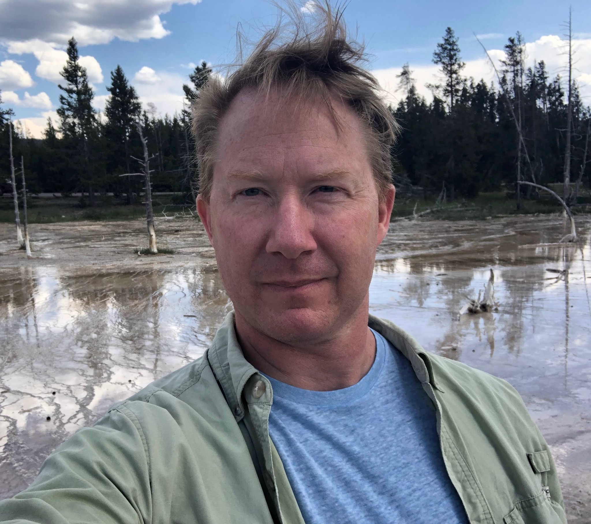 A man standing in front of some water